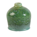 A small rounded ceramic vase with a short neck, featuring a glossy green glaze with white mottled speckling and a lighter teal-green base, shown on a white background with a product code and dimensions printed below.