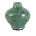 Green ceramic vase with speckled texture on a white background